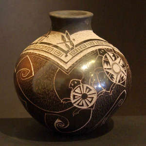 Sgraffito dragonflies, turtles and geometric designs on a black and brown jar