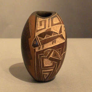 Sgraffito fish and geometric design on a brown jar with an oval opening