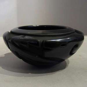 Avanyu design carved on a black bowl