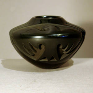Four direction thunderbird design carved into a black bowl