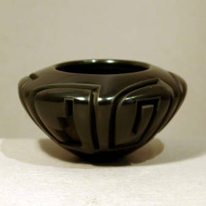Kiva step and spiral design carved in three panels on a black bowl