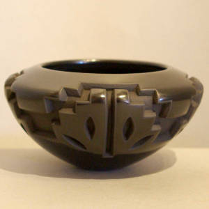 Kiva step and butterfly design carved into a black bowl