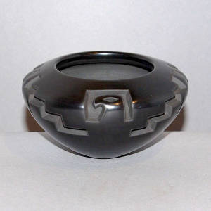 Thunderbird design carved into a black bowl