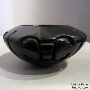 Four direction butterfly design carved into a black bowl