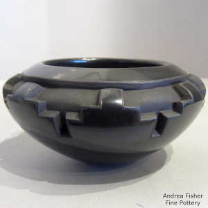 A kiva step design carved into a black bowl