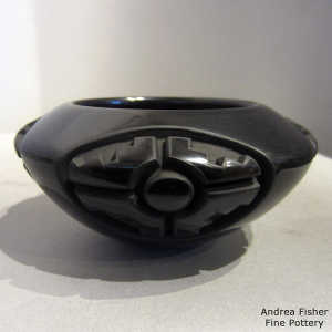 Four direction medallion and geometric design carved into a black bowl
