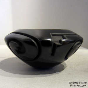Four direction spiral and kiva step design carved into a black bowl