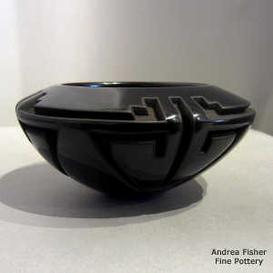 Kiva step and geometric design carved into a black bowl