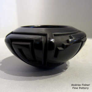 Kiva step, square scroll and geometric design carved into a black bowl