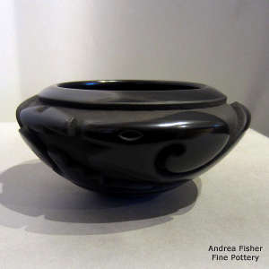Avanyu design carved into a black bowl