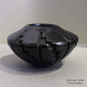 Kiva step and geometric design carved into a black bowl