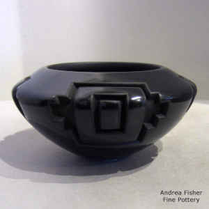 A geometric design carved into a black bowl