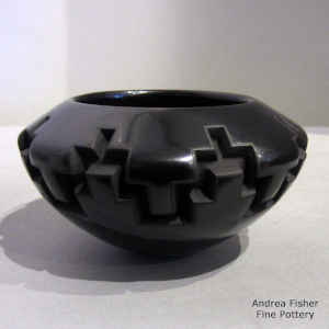 A kiva step design carved into a black bowl