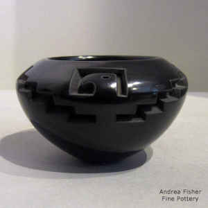 Thunderbird, kiva step and geometric design carved into a black bowl