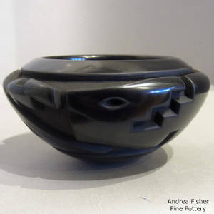 Avanyu design carved into a black bowl