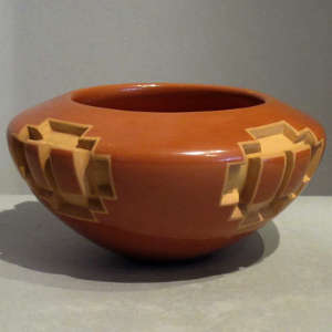 Carved geometric design on a red bowl