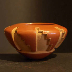 Kiva step designs carved into a polished red bowl