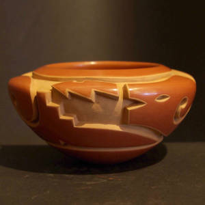 Avanyu design carved into a polished red bowl