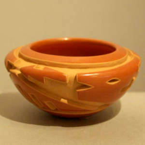 Avanyu design carved into a red jar