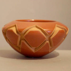 Geometric design carved in a polished red bowl