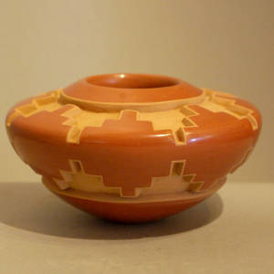 Geometric design carved into a red jar