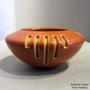 4 panel geometric design carved into a red bowl