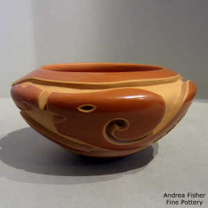 Avanyu and kiva step design carved into a red bowl
