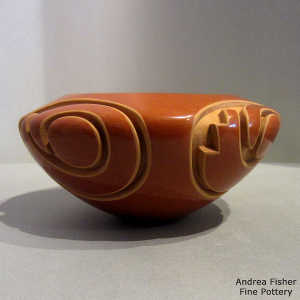 Kiva step, spiral and geometric design carved into a red bowl