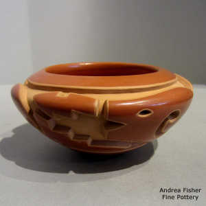 Avanyu design carved into a red bowl