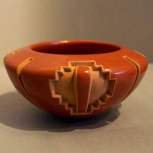 Four-panel geometric design carved into a red bowl