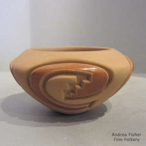 4-direction geometric design carved into a polished and matte red bowl