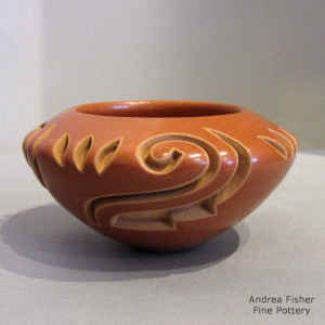 Kiva step, spiral and geometric design carved into a red bowl