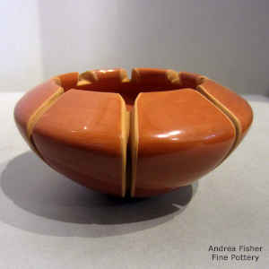 Melon design carved into a red bowl