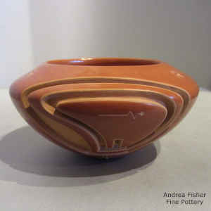 Bear design carved into a red bowl with a sgraffito heart line