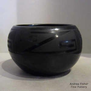 Black jar carved with a kiva step, avanyu and geometric design