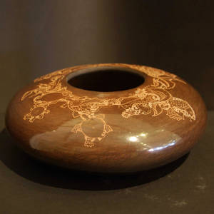 Sgraffito underwater designs on a polished brown jar