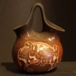 Sgraffito animal designs on a black and brown wedding vase