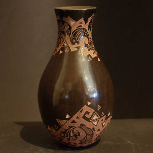 Sgraffito animal and geometric designs on a brown vase