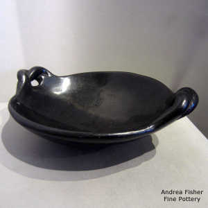 Twisted handles on a plain black serving dish