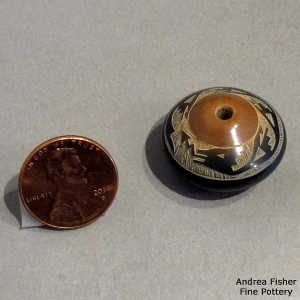 Sgraffito avanyu design on a miniature black seed pot with a sienna top