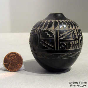Sgraffito feather, avanyu and geometric design on a miniature black jar