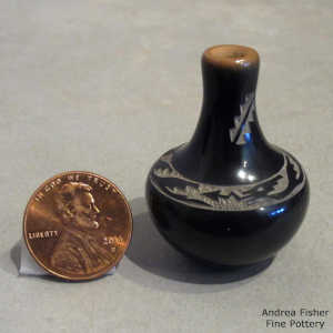 Miniature long neck black vase with a sienna rim and sgraffito avanyu design