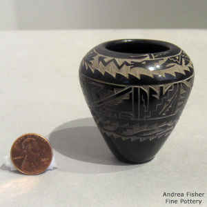 Miniature black jar decorated with a sgraffito avanyu and geometric design