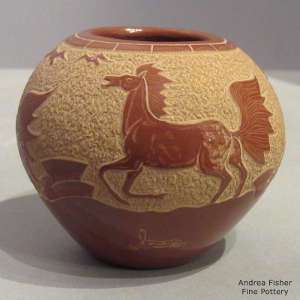 Sgraffito wild horse design on a red jar