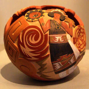Carved, sgraffito and painted woman, baskets and geometric design on a polychrome jar with an organic opening