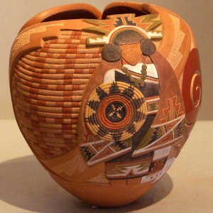 Carved and painted woman, basket, spiral and geometric design on a polychrome jar with organic opening
