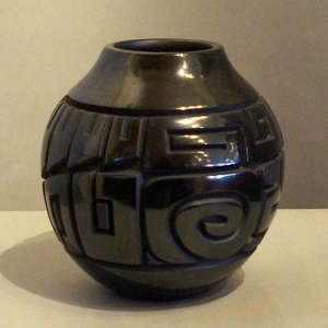 Tularosa spirals and geometric design carved into a black jar