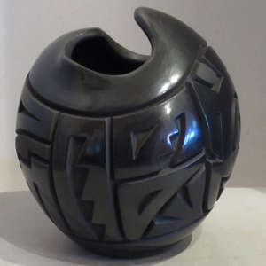 Black jar with organic opening carved with geometric design