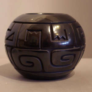 Geometric design carved into a black jar