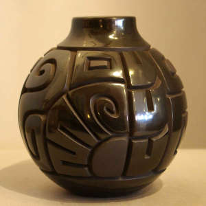 Geometric design carved into a black on black jar
